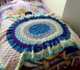 Rainbow-coloured knitted rug