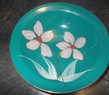 Green bowl with hand painted flowers on it