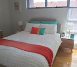 Coral, aqua and gold cushion and Adairs coral throw rug