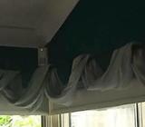 Wrought iron curtain rail with draping