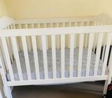 White cot with mattress