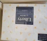 Baby cot and 2 x brand new sheet sets